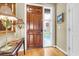 Inviting foyer with a wooden front door, side window, and hardwood floors at 225 Seven Farms Dr # 307, Daniel Island, SC 29492