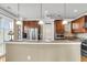 Kitchen features wood cabinets, stainless steel appliances, granite countertop and pendant lighting at 225 Seven Farms Dr # 307, Daniel Island, SC 29492