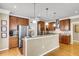 Modern kitchen featuring stainless steel appliances, wood cabinets, granite countertops, and an island at 225 Seven Farms Dr # 307, Daniel Island, SC 29492