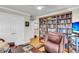 Well-appointed office with a full bookcase, white trim, hardwood floors, and an office chair at 225 Seven Farms Dr # 307, Daniel Island, SC 29492