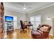 Inviting office with a traditional desk, leather chair and ottoman, hardwood floors, and abundant natural light at 225 Seven Farms Dr # 307, Daniel Island, SC 29492
