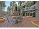 Outdoor patio seating area with tables, chairs, and black and white umbrellas at 225 Seven Farms Dr # 307, Daniel Island, SC 29492