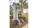 Smythe Park entrance with landscaped flowers, lush greenery, and a view of the lake at 225 Seven Farms Dr # 307, Daniel Island, SC 29492