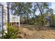 Spacious backyard with a brick house, deck, and mature trees creating a tranquil setting at 2356 Hut Creek Rd, Johns Island, SC 29455