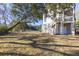 Backyard featuring a well-maintained lawn and mature trees, perfect for outdoor activities and relaxation at 2356 Hut Creek Rd, Johns Island, SC 29455