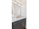Powder room features a gray vanity, bronze fixtures, marble countertop, and modern mirror at 2356 Hut Creek Rd, Johns Island, SC 29455