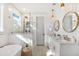 Bright bathroom features double sinks, stand alone tub, and glass enclosed shower with tiled walls and accents at 2356 Hut Creek Rd, Johns Island, SC 29455