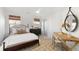 Bedroom features neutral colors, a ceiling fan, two windows, and a wooden desk at 2356 Hut Creek Rd, Johns Island, SC 29455