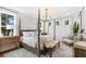 Serene bedroom with a four-poster bed, chandelier, and bright windows offering natural light at 2356 Hut Creek Rd, Johns Island, SC 29455