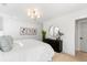 Light filled bedroom features white walls, a stylish chandelier, and a black dresser topped with decor at 2356 Hut Creek Rd, Johns Island, SC 29455