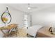 Bright bedroom with a desk, round mirror, ceiling fan, and a door leading to another room at 2356 Hut Creek Rd, Johns Island, SC 29455