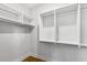 Walk in closet with adjustable white shelves and wooden floors provides generous storage space at 2356 Hut Creek Rd, Johns Island, SC 29455