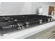 Close up of the KitchenAid stainless steel cooktop with quartz countertops in a modern kitchen at 2356 Hut Creek Rd, Johns Island, SC 29455