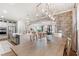 Open concept dining room featuring a brick archway, wooden table, and views of the kitchen and entry at 2356 Hut Creek Rd, Johns Island, SC 29455