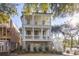 Two-story home with double balconies, white columns, brick foundation and staircase to main level at 2356 Hut Creek Rd, Johns Island, SC 29455