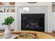Modern fireplace with marble surround, built-in shelving, and decorative accessories at 2356 Hut Creek Rd, Johns Island, SC 29455