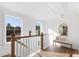 Upstairs hallway features warm wood floors, a bench with pillows and natural light from large windows at 2356 Hut Creek Rd, Johns Island, SC 29455