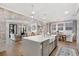 Modern kitchen with open layout, spacious island, light gray cabinetry and stainless steel appliances at 2356 Hut Creek Rd, Johns Island, SC 29455