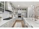 Close up of stainless steel cooktop and white quartz countertops in a modern, light-filled kitchen at 2356 Hut Creek Rd, Johns Island, SC 29455
