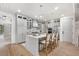 Bright, modern kitchen featuring a center island with seating, pendant lights and stainless steel appliances at 2356 Hut Creek Rd, Johns Island, SC 29455