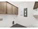 Laundry room with black hexagon tile flooring, custom cabinets, and new appliances at 2356 Hut Creek Rd, Johns Island, SC 29455
