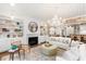 Bright, open living room with hardwood floors, built-in shelving, and a cozy fireplace at 2356 Hut Creek Rd, Johns Island, SC 29455