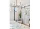 Bright bedroom with a chandelier, sliding barn door, and views into a luxurious bathroom with a soaking tub at 2356 Hut Creek Rd, Johns Island, SC 29455