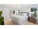 Bright main bedroom features a gray upholstered headboard, a chandelier, a private balcony and plenty of natural light at 2356 Hut Creek Rd, Johns Island, SC 29455