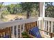 Cozy porch features two chairs with custom throw pillows and views of the marsh at 2356 Hut Creek Rd, Johns Island, SC 29455