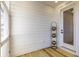 Enclosed porch with potted plants, and a white door, providing a relaxing outdoor space at 2356 Hut Creek Rd, Johns Island, SC 29455