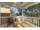 Cozy porch features two chairs with custom throw pillows and views of the trees at 2356 Hut Creek Rd, Johns Island, SC 29455