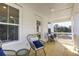 Cozy porch with comfortable wicker chairs and a view of the surrounding foliage at 2356 Hut Creek Rd, Johns Island, SC 29455