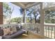 Cozy screened-in porch with comfortable seating and a picturesque view of the surrounding trees at 2356 Hut Creek Rd, Johns Island, SC 29455