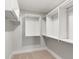A bright walk-in closet features built in shelving and metal hanging rods to maximize storage space at 2356 Hut Creek Rd, Johns Island, SC 29455