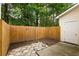 Private backyard area featuring a wooden fence, concrete patio, and access door at 241 Howle Ave # G, Charleston, SC 29412
