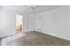 Neutral bedroom with a ceiling fan and carpet, showcasing views of an en-suite bathroom and closet at 241 Howle Ave # G, Charleston, SC 29412