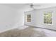 Bright bedroom featuring neutral carpet, ceiling fan, two large windows, and ample natural light at 241 Howle Ave # G, Charleston, SC 29412