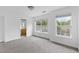Carpeted bedroom with two windows, connecting to an en-suite bathroom featuring a wood vanity at 241 Howle Ave # G, Charleston, SC 29412