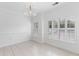 Well-lit dining area featuring a modern chandelier and bright white walls at 241 Howle Ave # G, Charleston, SC 29412
