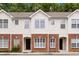 Charming townhouse exterior with brick accents, white siding, and well-lit entrances at 241 Howle Ave # G, Charleston, SC 29412