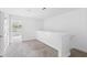 A hallway features neutral walls and carpet, an overhead light, and leads to another room at 241 Howle Ave # G, Charleston, SC 29412