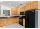 Well-lit kitchen featuring wood cabinets and black appliances at 241 Howle Ave # G, Charleston, SC 29412