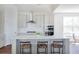Charming kitchen with a kitchen island featuring seating, stainless appliances, and modern cabinets at 2553 Hut Creek Rd, Johns Island, SC 29455