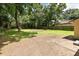 Expansive back yard with mature trees, grass, and a sturdy wooden fence line at 2704 Orchid Ave, North Charleston, SC 29405