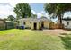 A cozy backyard featuring a well-maintained lawn and a charming painted house at 2704 Orchid Ave, North Charleston, SC 29405