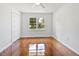 Bright bedroom features hardwood floors, double door closet, and a large window with a pleasant view at 2704 Orchid Ave, North Charleston, SC 29405