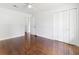 Large bedroom with hardwood floors, a ceiling fan, closet and entry door at 2704 Orchid Ave, North Charleston, SC 29405