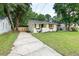 A lovely home with a well-manicured lawn and a long concrete driveway at 2704 Orchid Ave, North Charleston, SC 29405