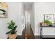 Hallway with hardwood floors, white walls, and stylish decor, offering a clean and modern aesthetic at 2704 Orchid Ave, North Charleston, SC 29405