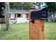 Close-up of a stylish black mailbox, with a charming home in the background at 2704 Orchid Ave, North Charleston, SC 29405